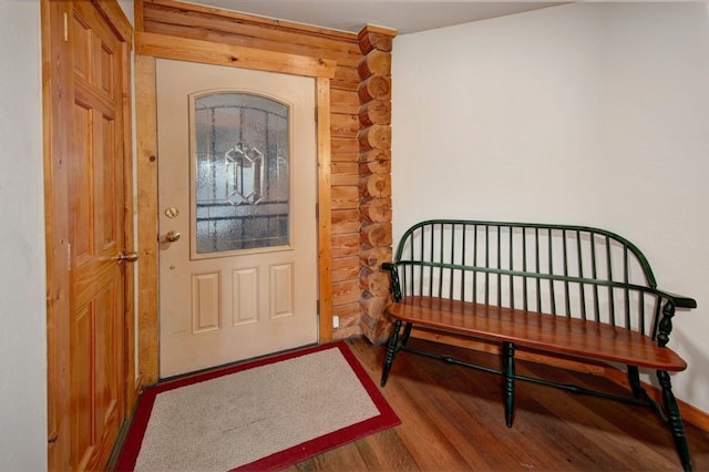 entryway with hardwood / wood-style flooring and rustic walls