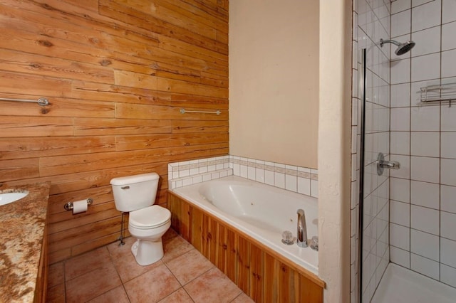 full bathroom featuring tile patterned floors, toilet, wood walls, vanity, and independent shower and bath