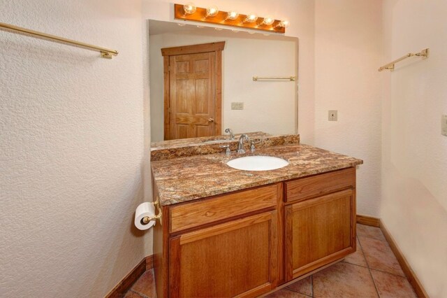 bathroom with tile patterned flooring and vanity