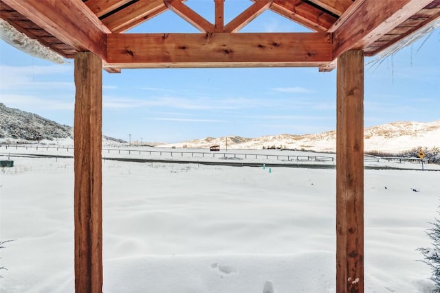 snowy yard featuring a mountain view