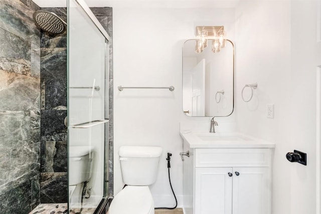 bathroom with vanity, toilet, and tiled shower