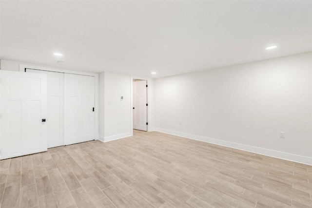 unfurnished bedroom featuring light hardwood / wood-style flooring and a closet