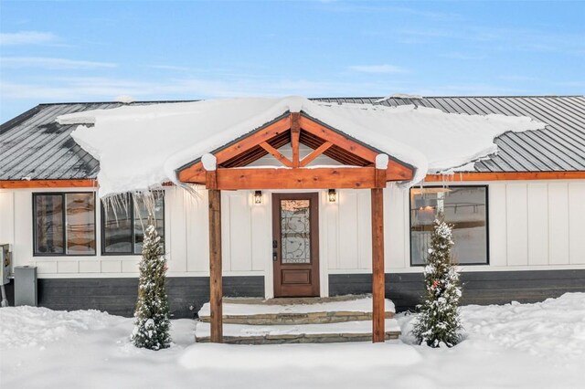 view of snow covered property entrance