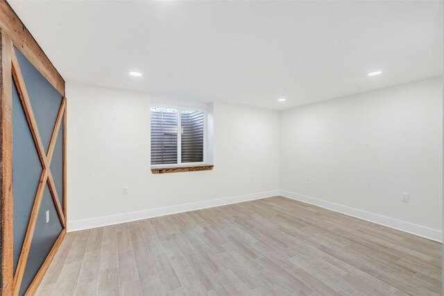 empty room with light hardwood / wood-style flooring