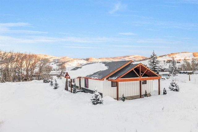 snow covered structure featuring a mountain view