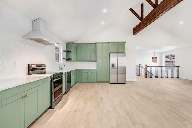 kitchen featuring sink, stainless steel appliances, green cabinets, decorative light fixtures, and exhaust hood