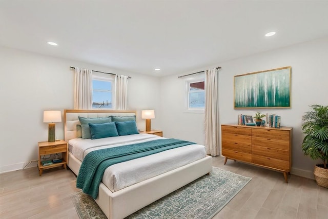 bedroom featuring multiple windows and hardwood / wood-style floors