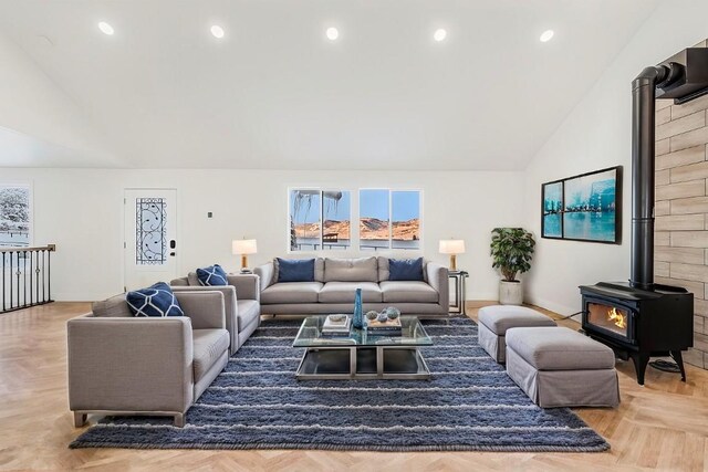 living room featuring light parquet flooring, a wood stove, and lofted ceiling