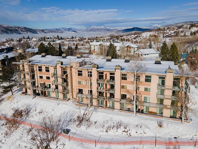 snowy aerial view with a mountain view