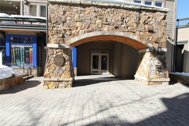 entrance to property with stone siding