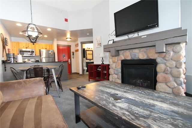 living room with recessed lighting, a fireplace, dark carpet, and baseboards