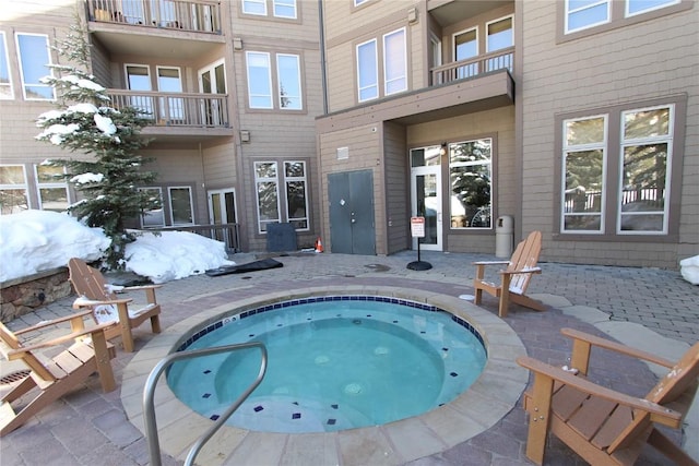 view of pool with an indoor hot tub