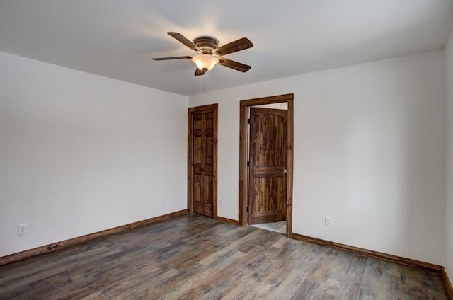 unfurnished room featuring a ceiling fan, baseboards, and wood finished floors