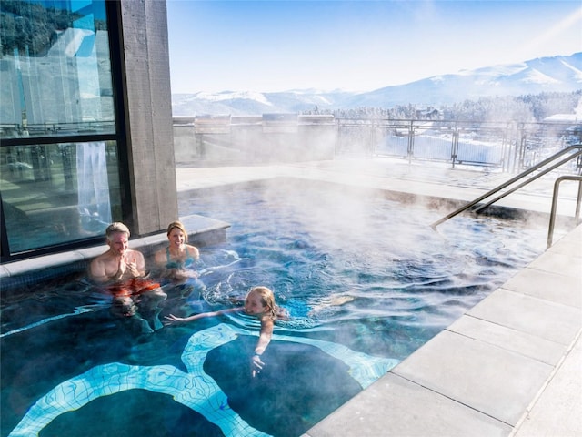 view of swimming pool with a mountain view