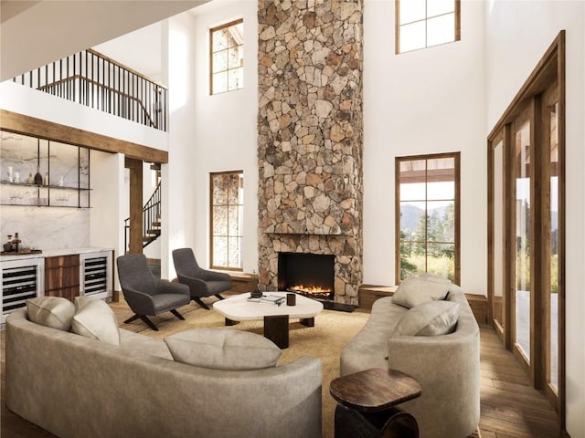 living room featuring a wealth of natural light, wine cooler, a dry bar, and wood finished floors