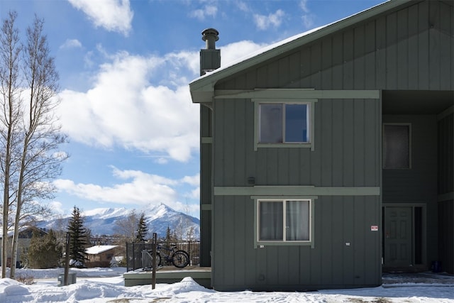 snow covered property featuring a mountain view