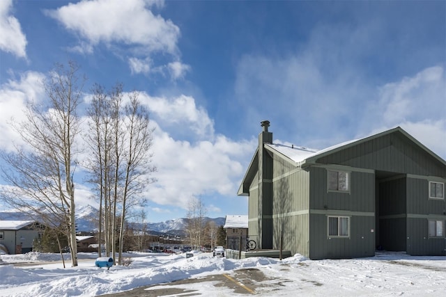 view of snowy exterior with a mountain view