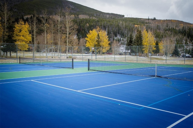 view of sport court with basketball court and a mountain view