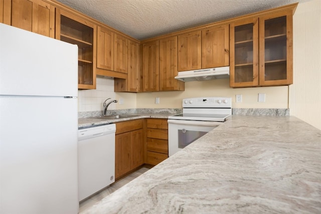 kitchen with white appliances, a textured ceiling, and sink