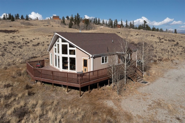 back of house with a rural view and a wooden deck