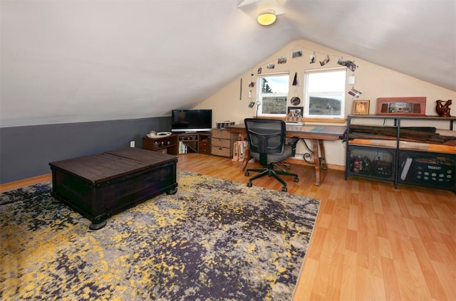 home office featuring lofted ceiling and hardwood / wood-style flooring