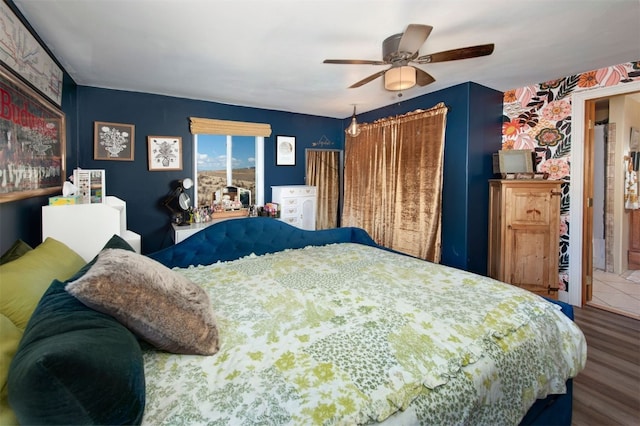 bedroom featuring connected bathroom, ceiling fan, and hardwood / wood-style floors