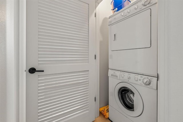 clothes washing area with stacked washer / dryer