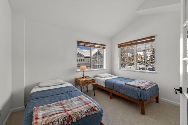 bedroom featuring light colored carpet and lofted ceiling