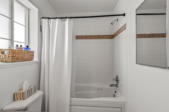 bathroom featuring toilet and shower / tub combo