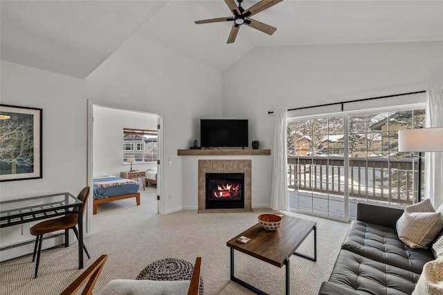 carpeted living room featuring a tile fireplace, a baseboard heating unit, ceiling fan, and high vaulted ceiling