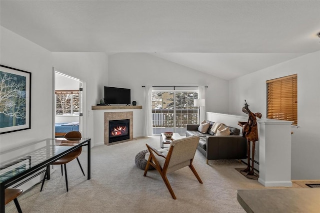 living room with light carpet, a fireplace, and lofted ceiling