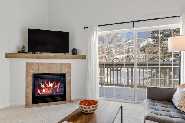 carpeted living room with a fireplace