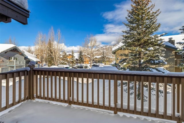 view of snow covered back of property