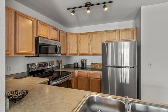 kitchen featuring stainless steel appliances and sink