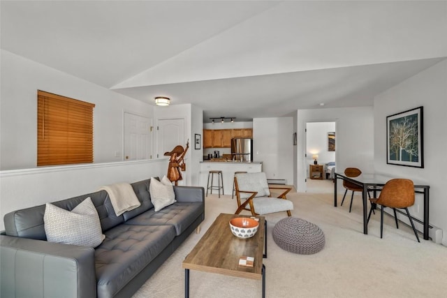 carpeted living room with a baseboard radiator and lofted ceiling