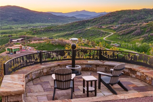 patio terrace at dusk with a mountain view