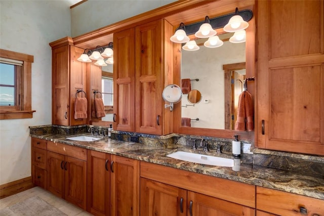 bathroom with tile patterned floors, vanity, and a wealth of natural light