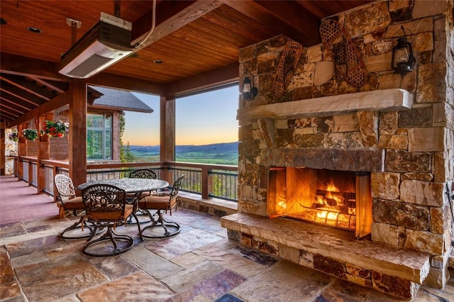 patio terrace at dusk with an outdoor stone fireplace