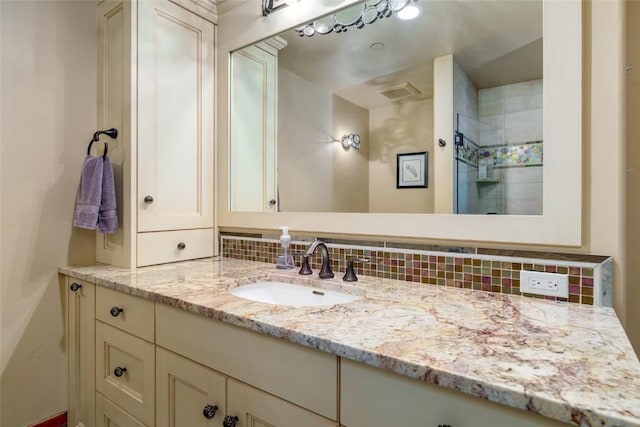 bathroom featuring decorative backsplash and vanity