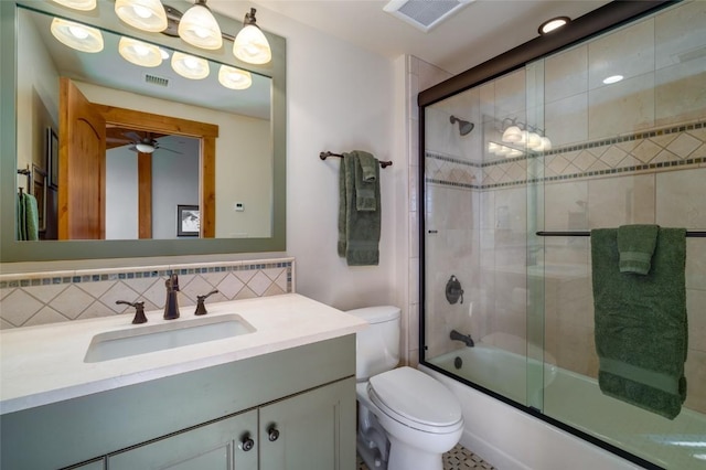 full bathroom featuring tasteful backsplash, vanity, ceiling fan, shower / bath combination with glass door, and toilet