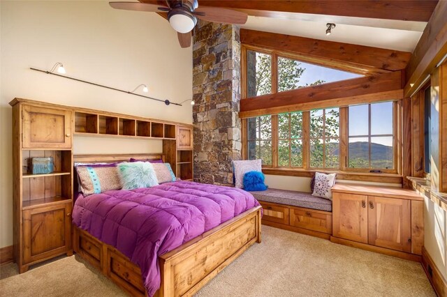 carpeted bedroom featuring ceiling fan and high vaulted ceiling