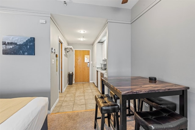 tiled dining space with ceiling fan