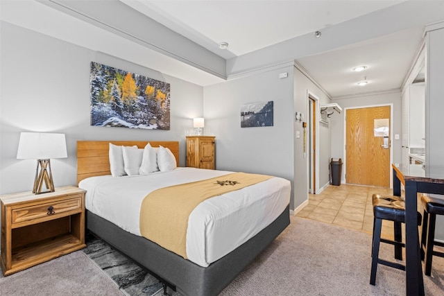 bedroom with carpet, connected bathroom, and ornamental molding