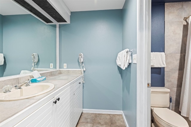 bathroom featuring tile patterned flooring, vanity, and toilet