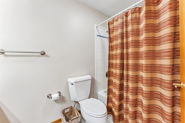 bathroom with toilet and shower / bath combo with shower curtain