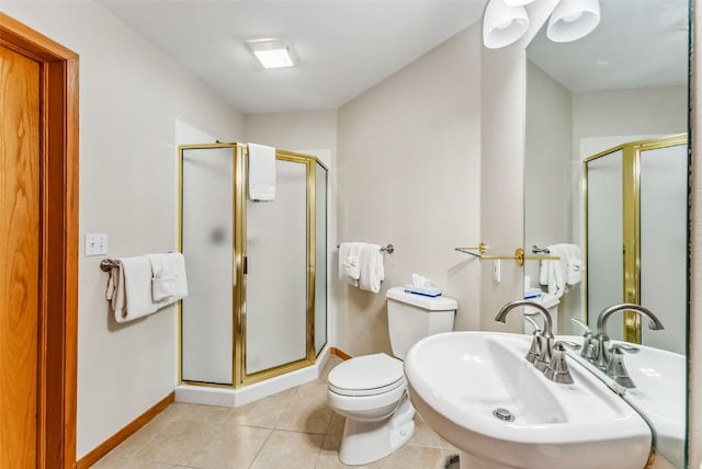 bathroom with tile patterned floors, toilet, sink, and walk in shower