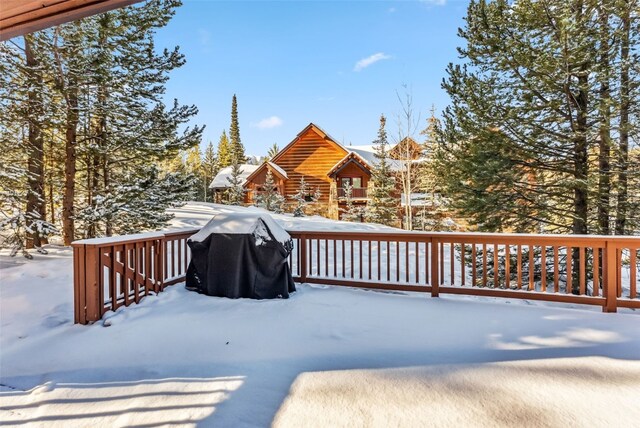 snow covered deck featuring area for grilling