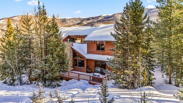 view of front of home featuring a deck with mountain view