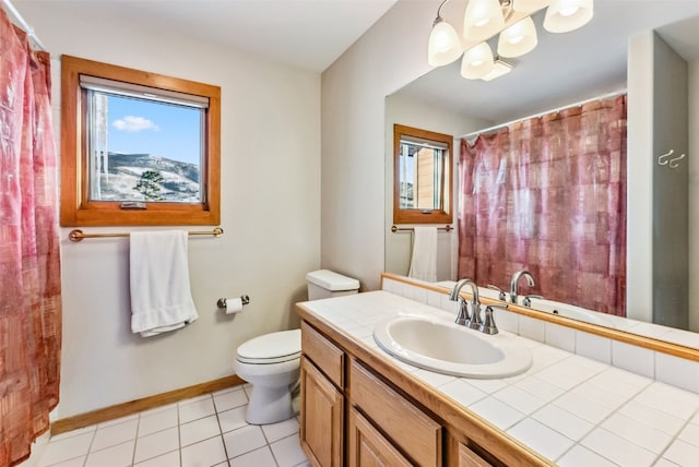 bathroom featuring tile patterned floors, vanity, and toilet