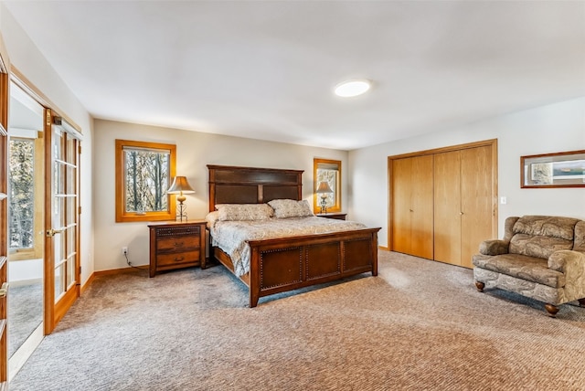 bedroom with a closet, light colored carpet, and multiple windows